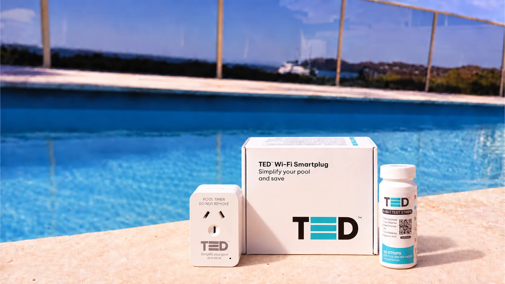 The TED smart plug, box and test strips on the edge of a pool with water views
